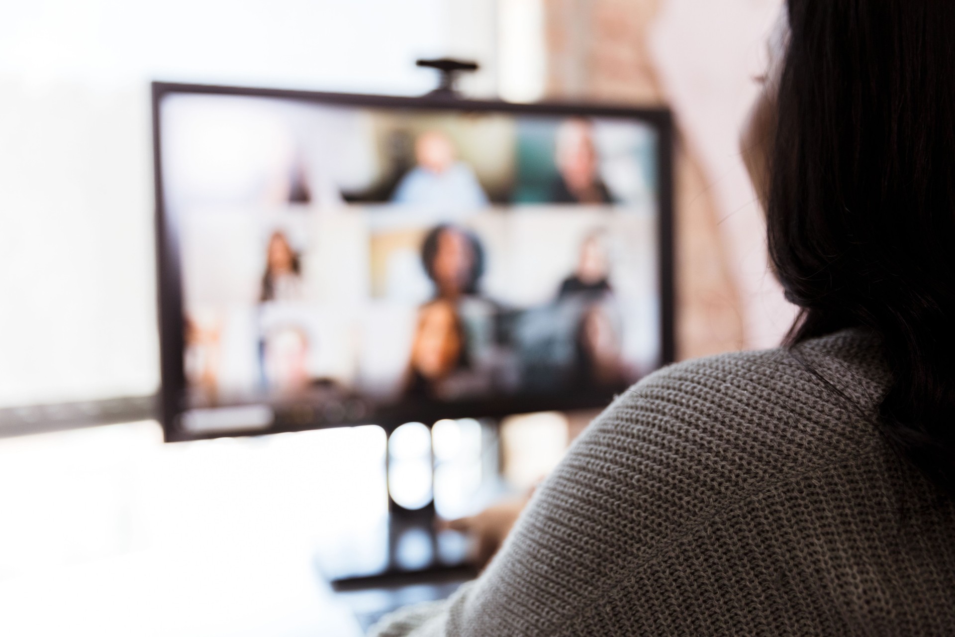 Woman and team meet via video conference